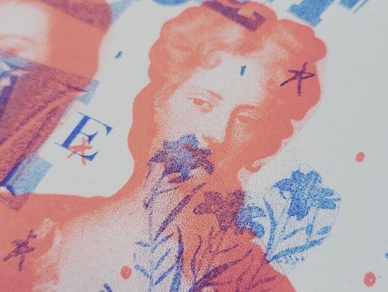 Delicate orange image of woman's face overprinted with blue flowers
