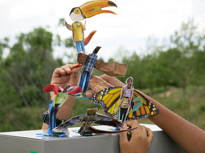 Collaged puppet animal 'avatars' held up by pupils exploring the Olympic Park.