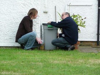 Two men examining the Vibe Cube C work